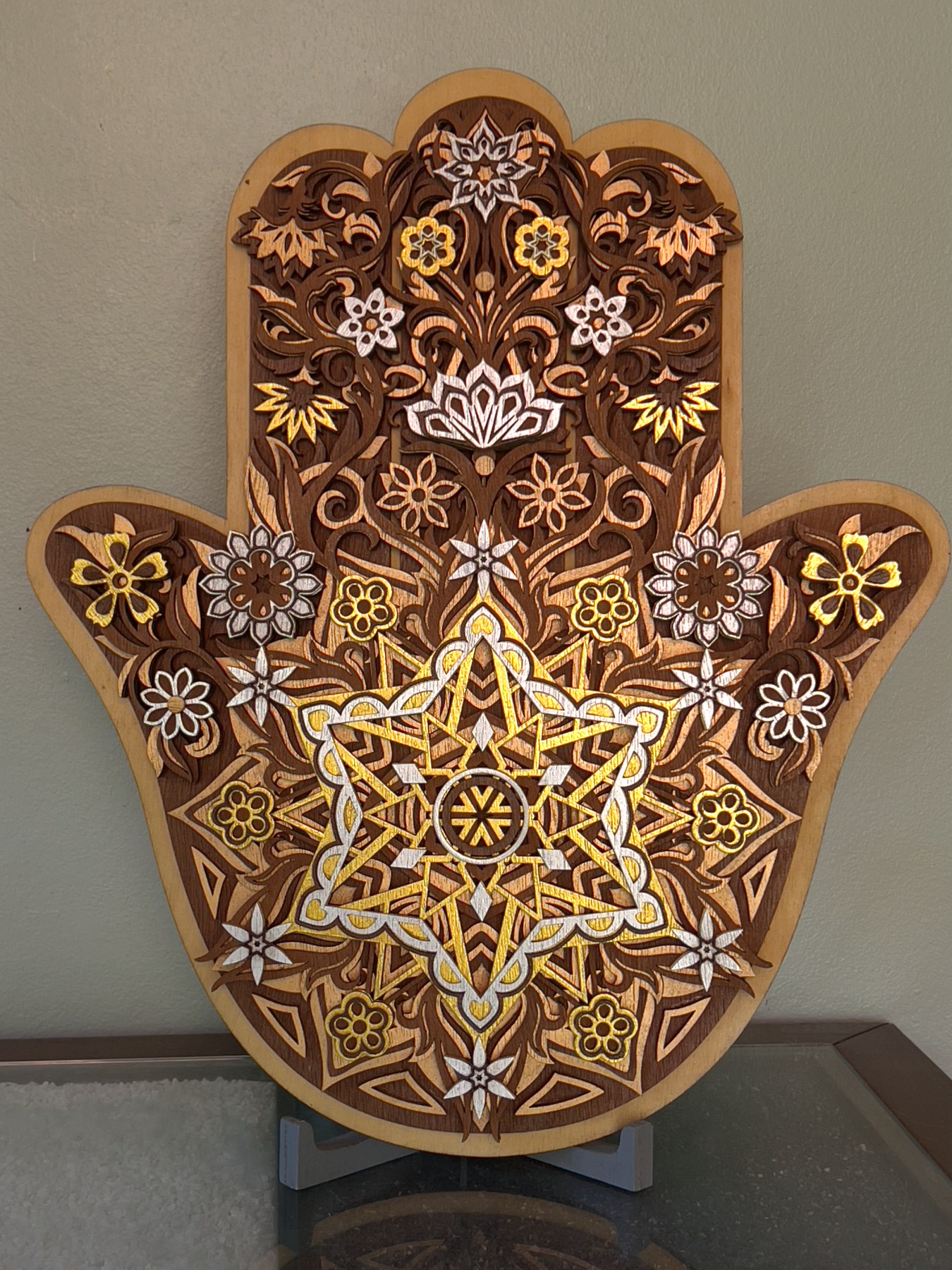 Layered laser-cut wooden Hamsa by TripleVision
